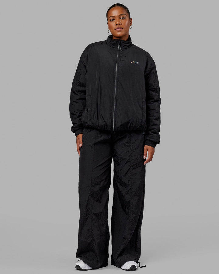 Woman wearing Unisex Amplify Bomber Jacket - Black