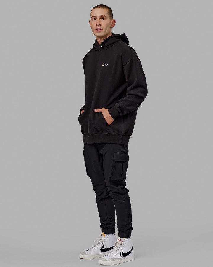 Man wearing Unisex Amplify Hoodie Oversize - Pride-Black