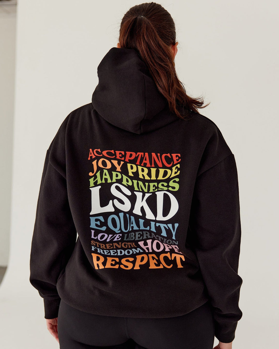 Woman wearing Unisex Amplify Hoodie Oversize - Pride-Black
