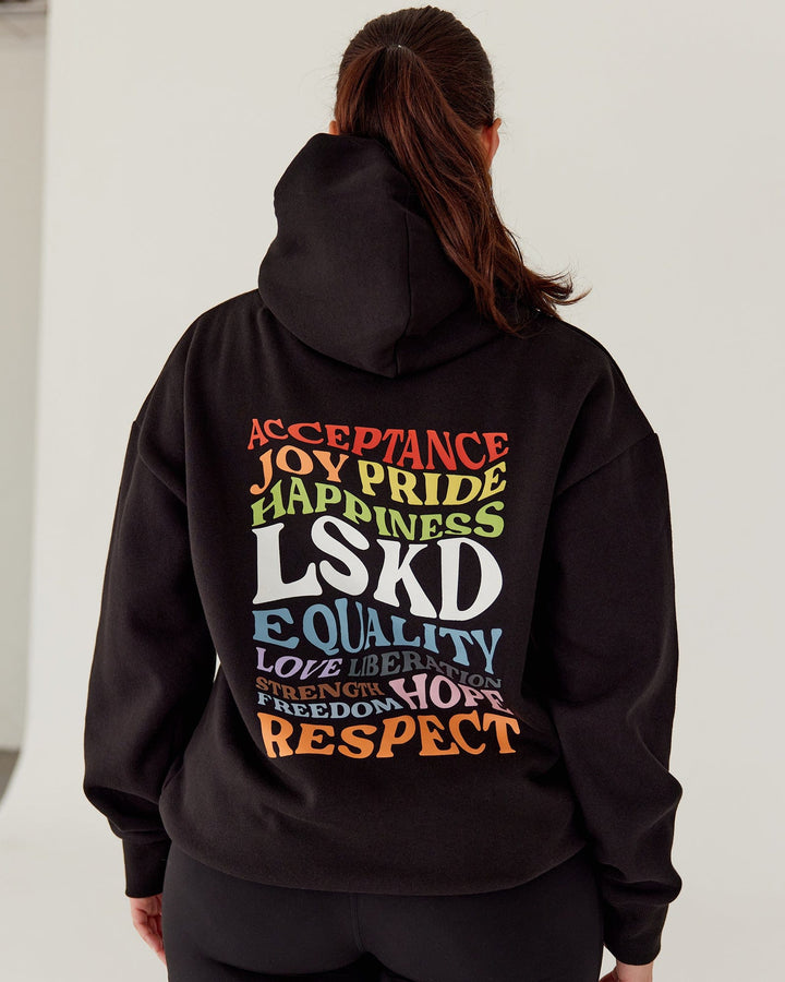Woman wearing Unisex Amplify Hoodie Oversize - Pride-Black