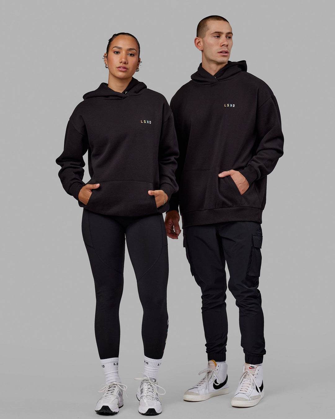 Duo wearing Unisex Amplify Hoodie Oversize - Pride-Black