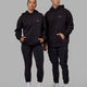 Duo wearing Unisex Amplify Hoodie Oversize - Pride-Black