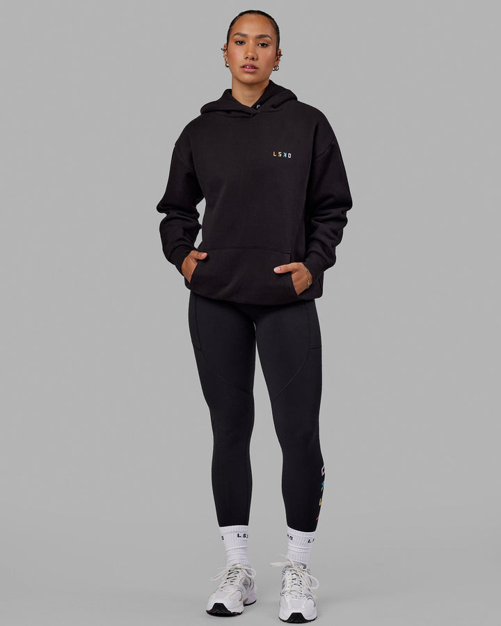 Woman wearing Unisex Amplify Hoodie Oversize - Pride-Black