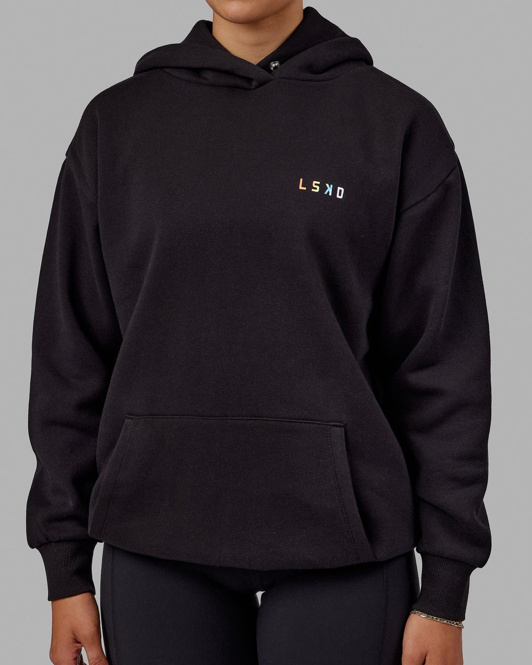 Woman wearing Unisex Amplify Hoodie Oversize - Pride-Black