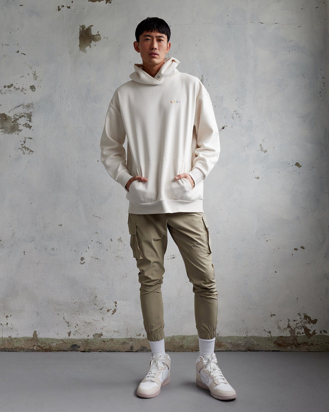 Man wearing Unisex Amplify Hoodie Oversize - Pride-Off White