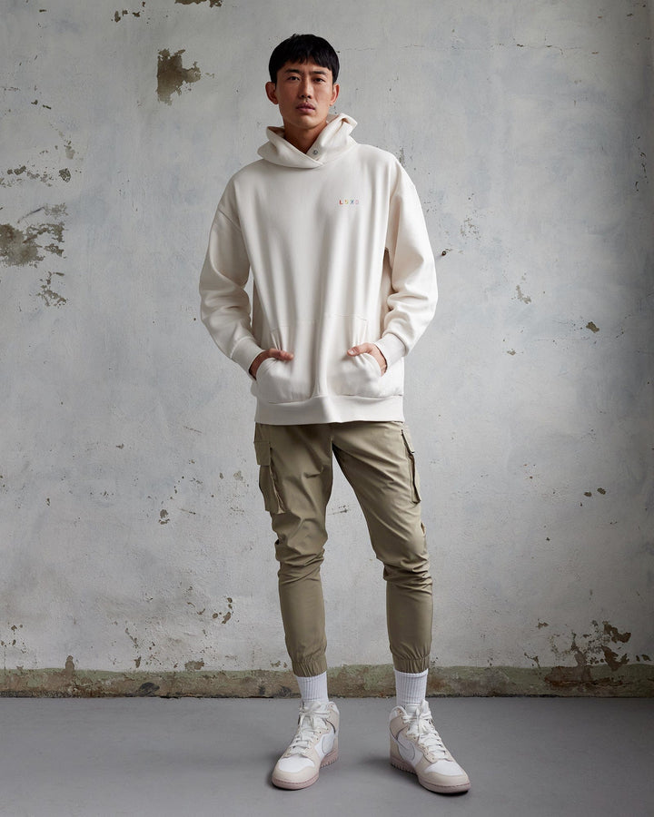 Man wearing Unisex Amplify Hoodie Oversize - Pride-Off White