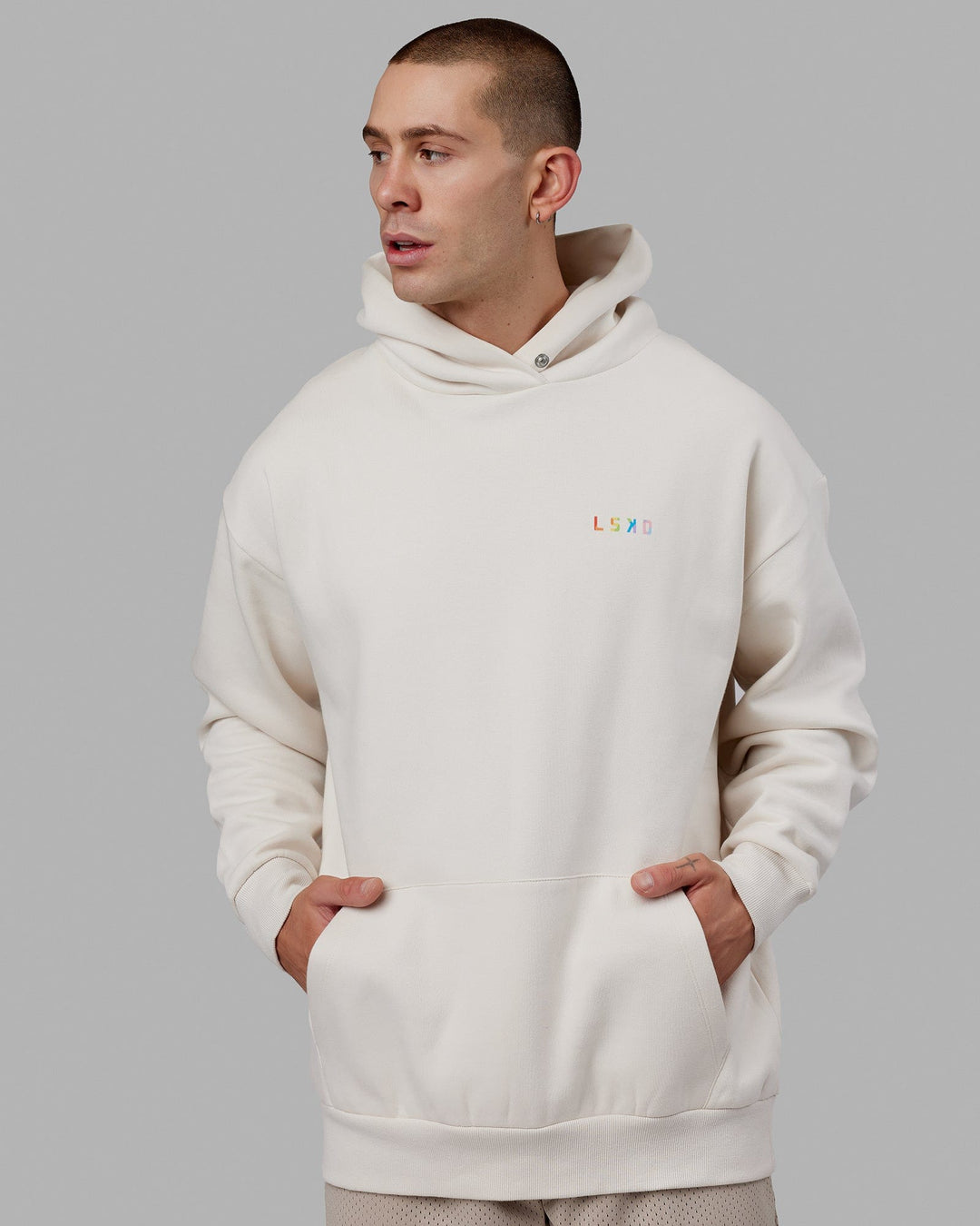 Man wearing Unisex Amplify Hoodie Oversize - Pride-Off White