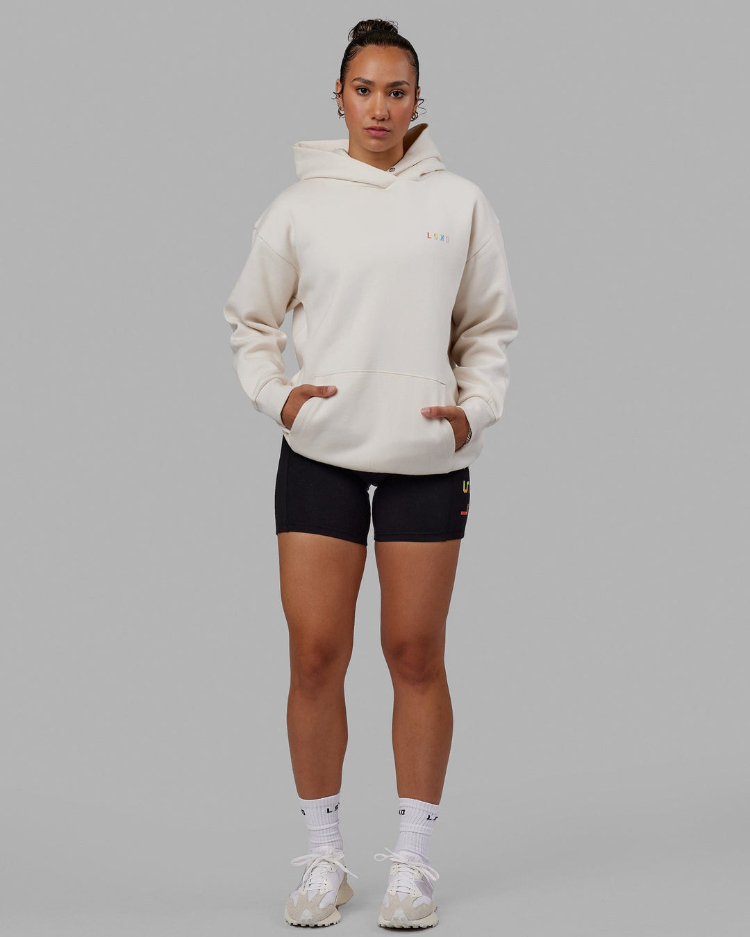 Woman wearing Unisex Amplify Hoodie Oversize - Pride-Off White
