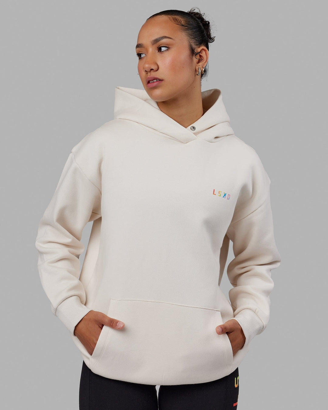 Woman wearing Unisex Amplify Hoodie Oversize - Pride-Off White