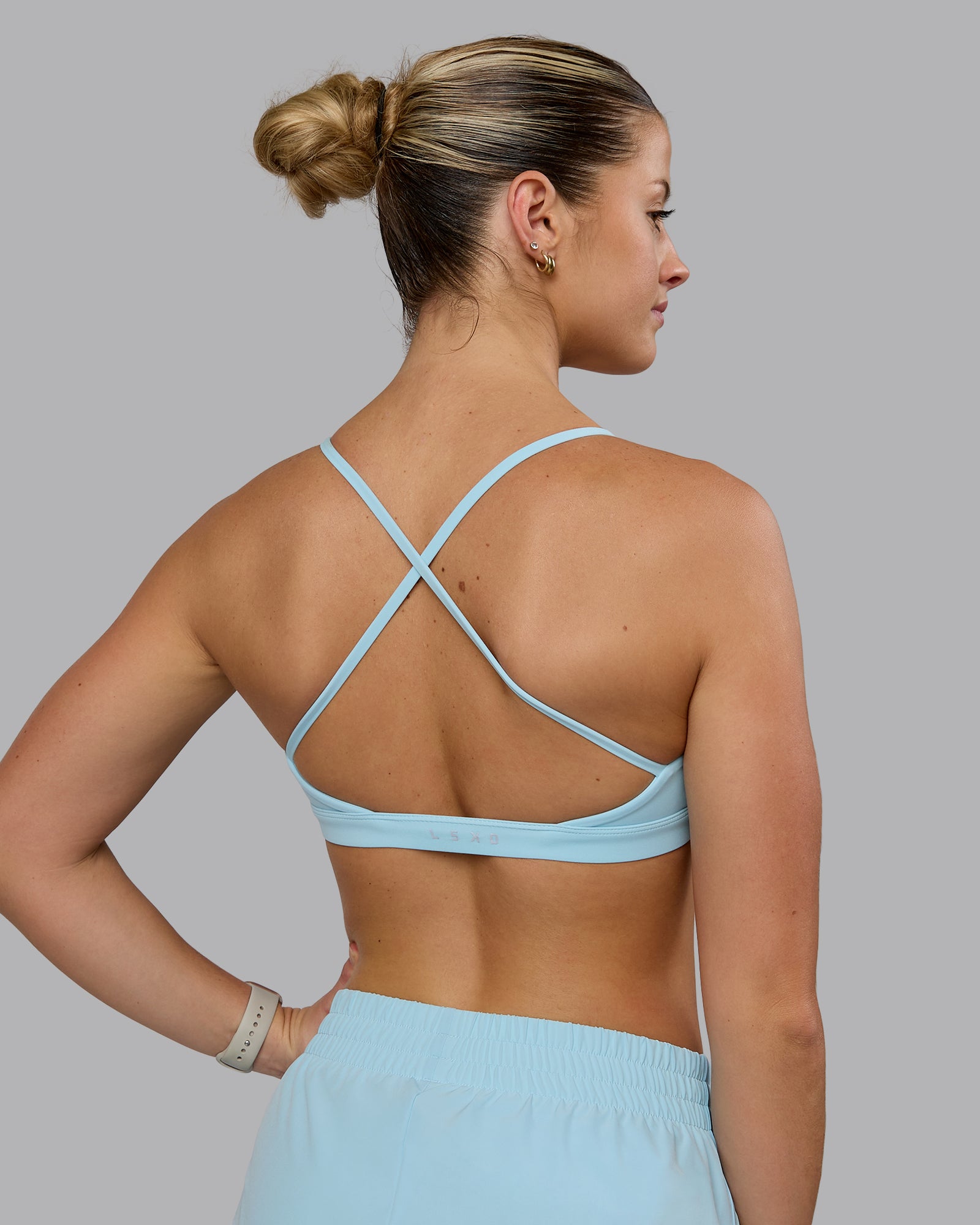 Woman wearing Ascend Sports Bra - Crystal Blue
