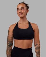 Woman wearing Aspire Sports Bra - Black
