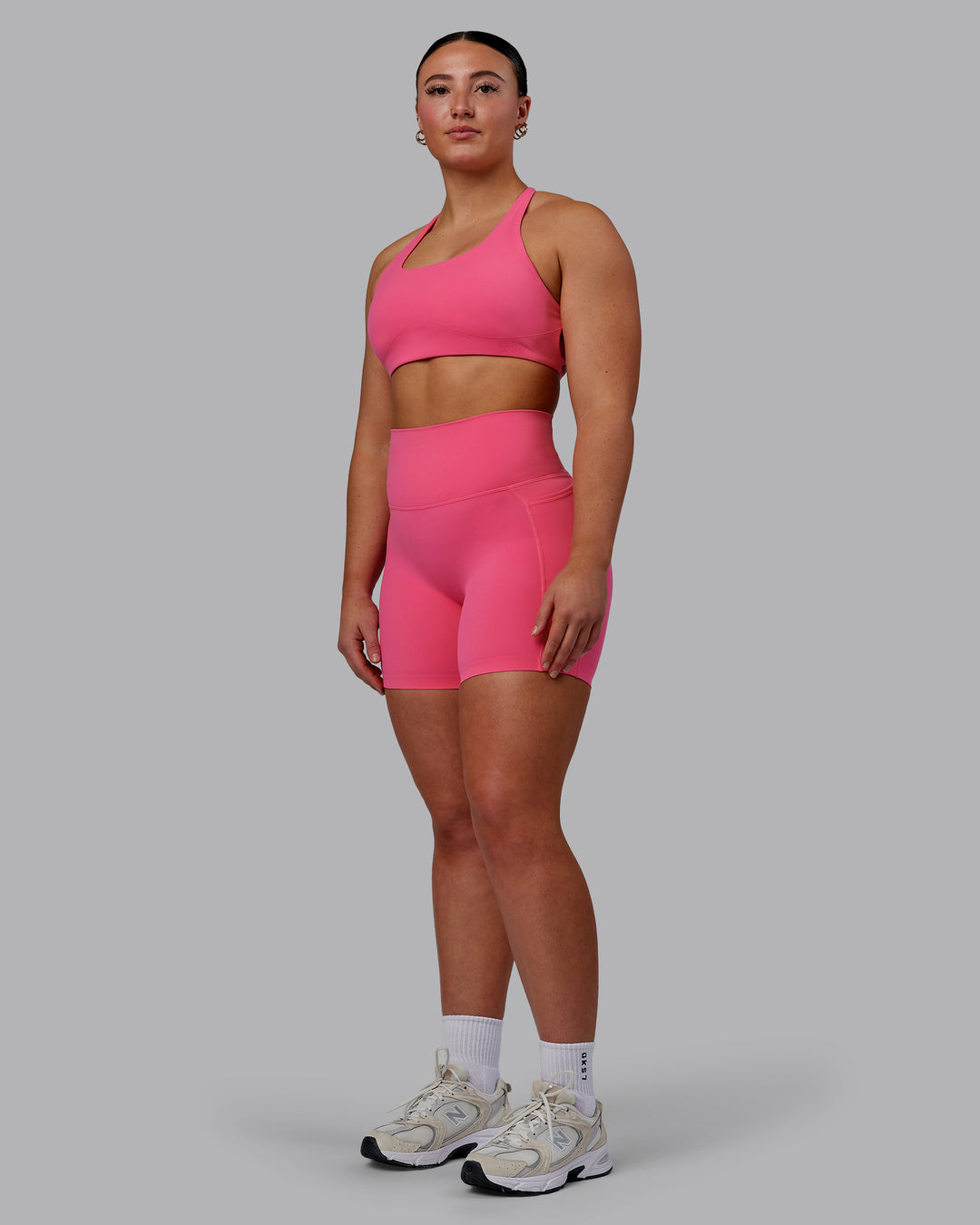 Woman wearing Aspire Sports Bra - Carmine Rose