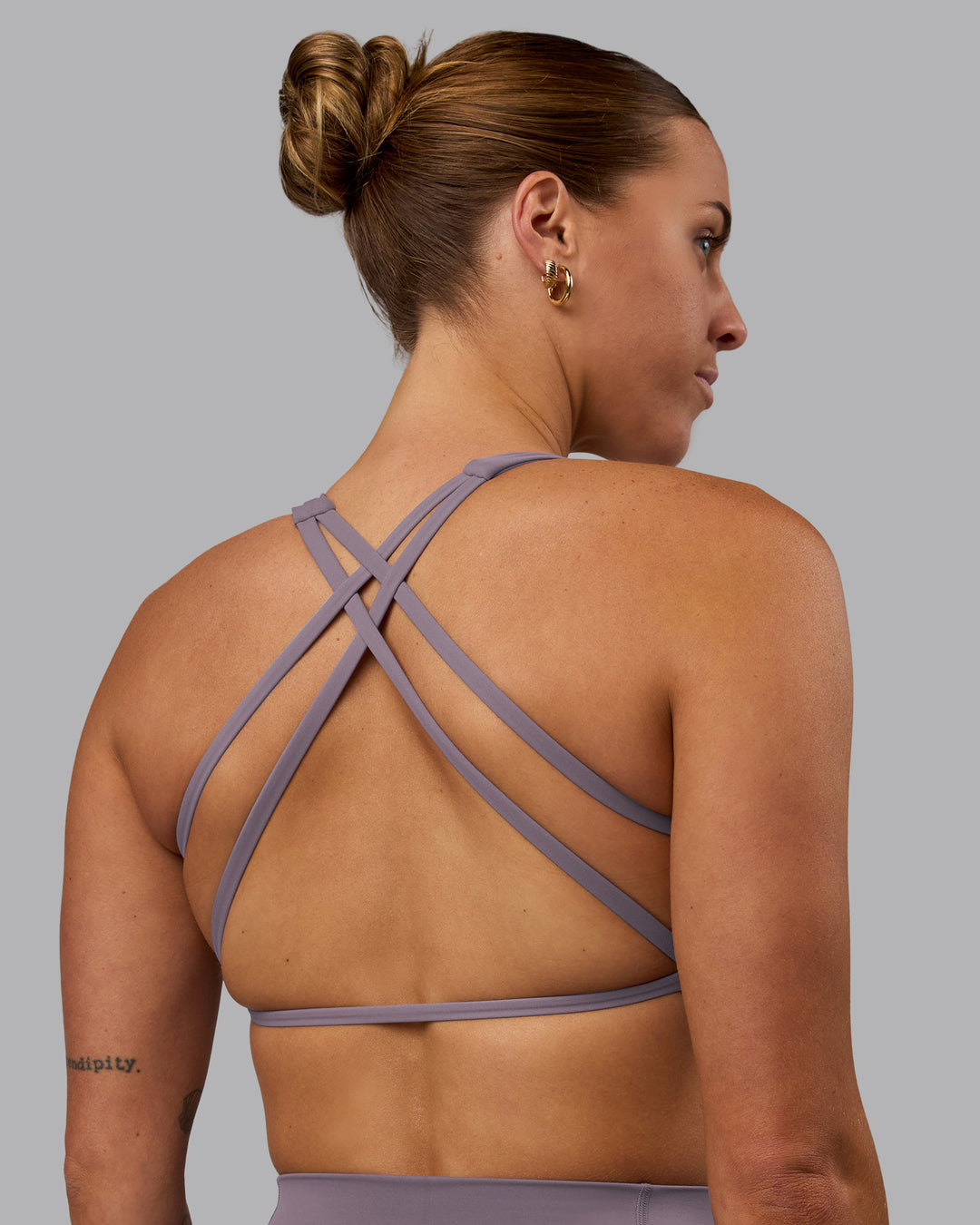 Woman wearing Aspire Sports Bra - Purple Sage