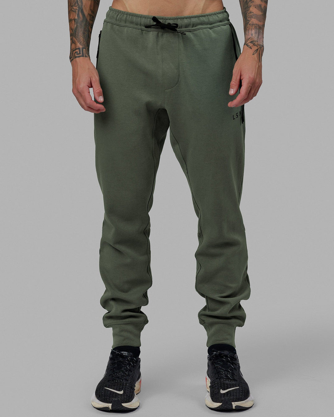 Man wearing Athlete ForgedFleece Zip Track Pants - Dark Forest