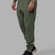 Man wearing Athlete ForgedFleece Zip Track Pants - Dark Forest