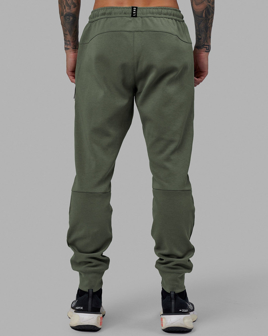 Man wearing Athlete ForgedFleece Zip Track Pants - Dark Forest