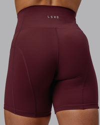 Woman wearing Bend Ultra High-Rise 6" Short - Dark Cherry