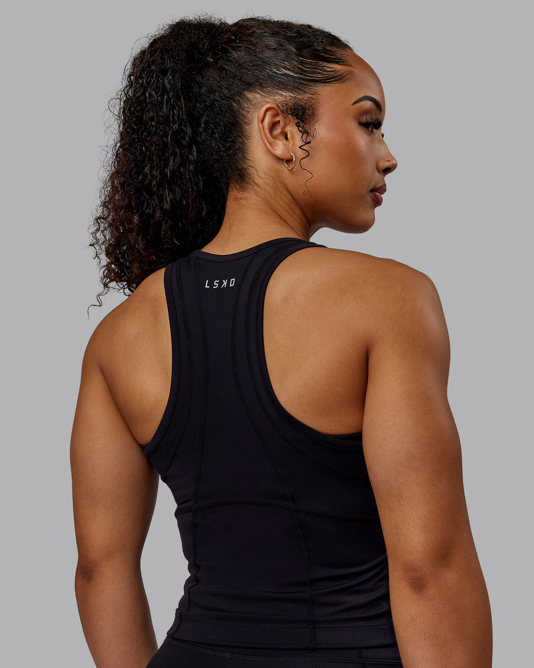 Woman wearing Bend Performance Tank - Black