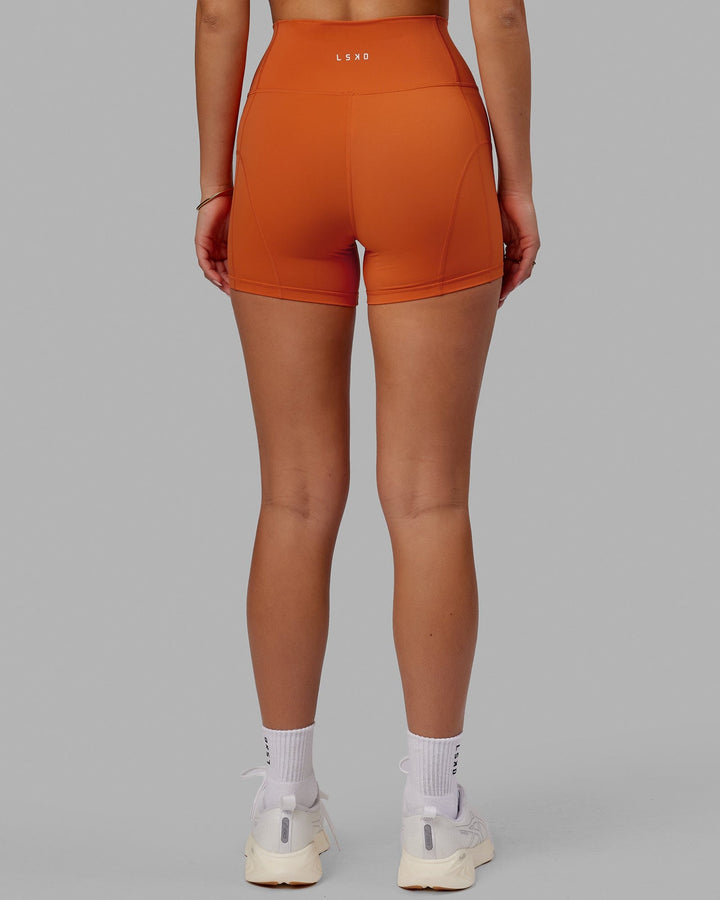 Woman wearing Bend X-Short Tight - Burnt Orange