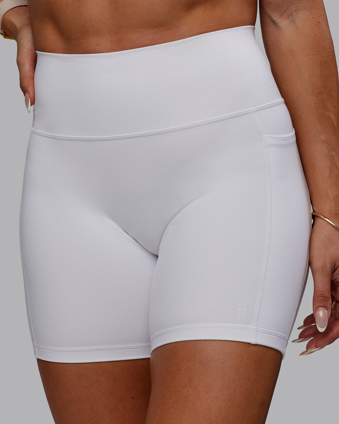 Woman wearing Bree Masters Fusion Ultra High-Rise 6&quot; Short Pockets - White