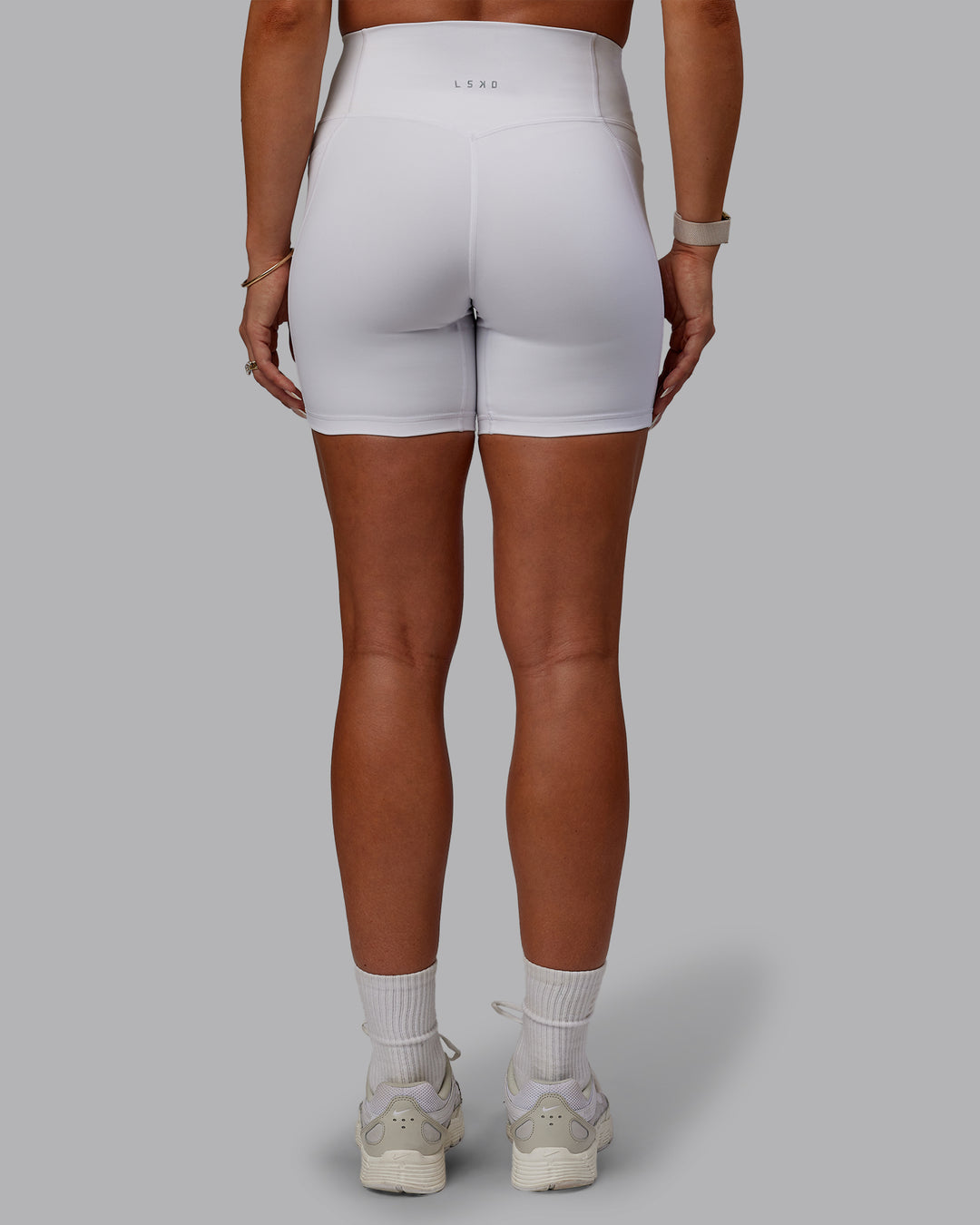 Woman wearing Bree Masters Fusion Ultra High-Rise 6&quot; Short Pockets - White