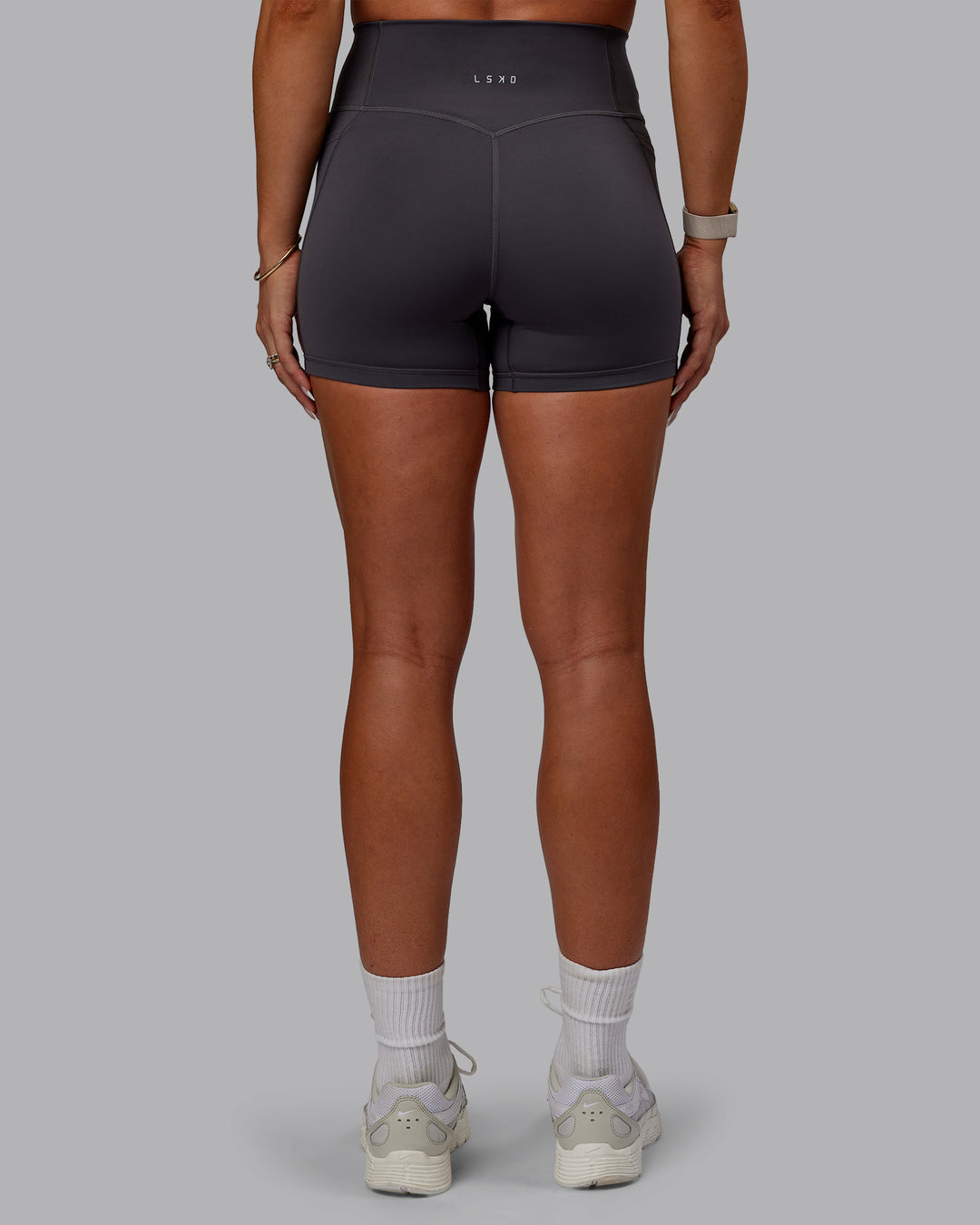 Woman wearing Bree Masters Fusion Ultra High-Rise 4&quot; Short Pockets - Stormy