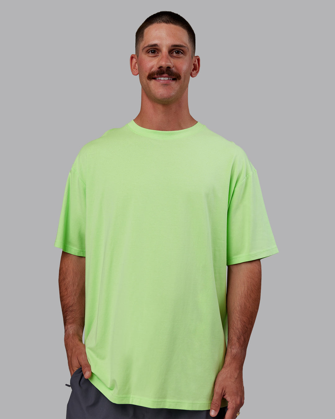 Man wearing Bree Masters Unisex Vision FLXCotton Tee Oversize - Pastel Lime-Stormy