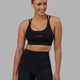 Woman wearing Bridge Sports Bra - Black-Raspberry