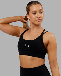 Woman wearing Bridge Sports Bra - Black-White