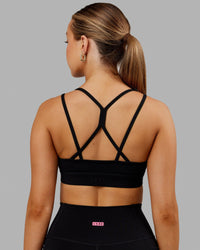 Woman wearing Bridge Sports Bra - Black-White