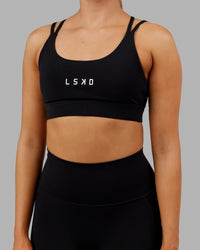 Woman wearing Bridge Sports Bra - Black-White