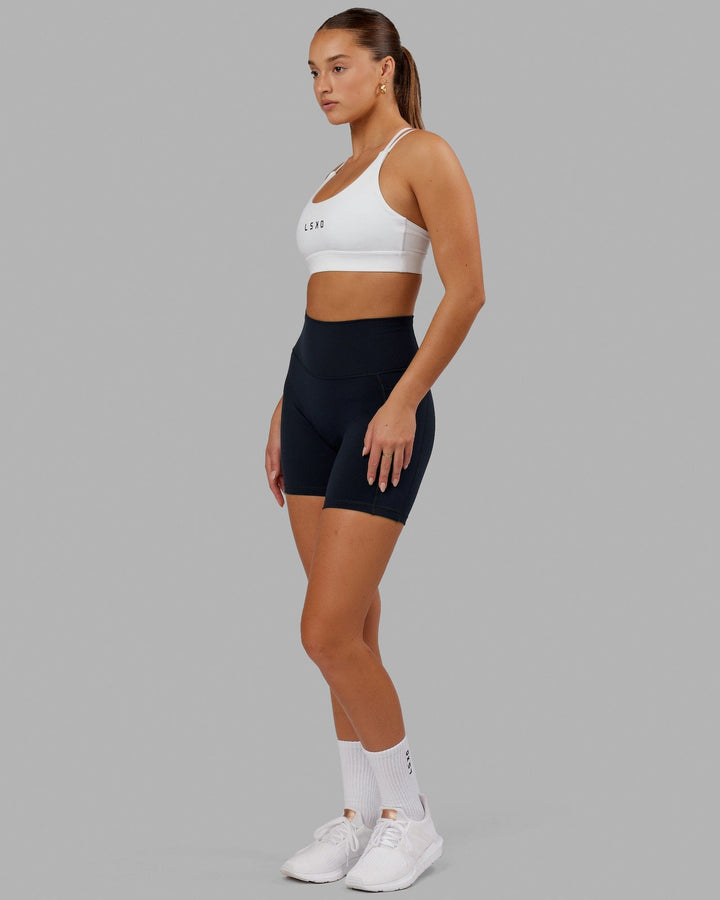 Woman wearing Bridge Sports Bra - White