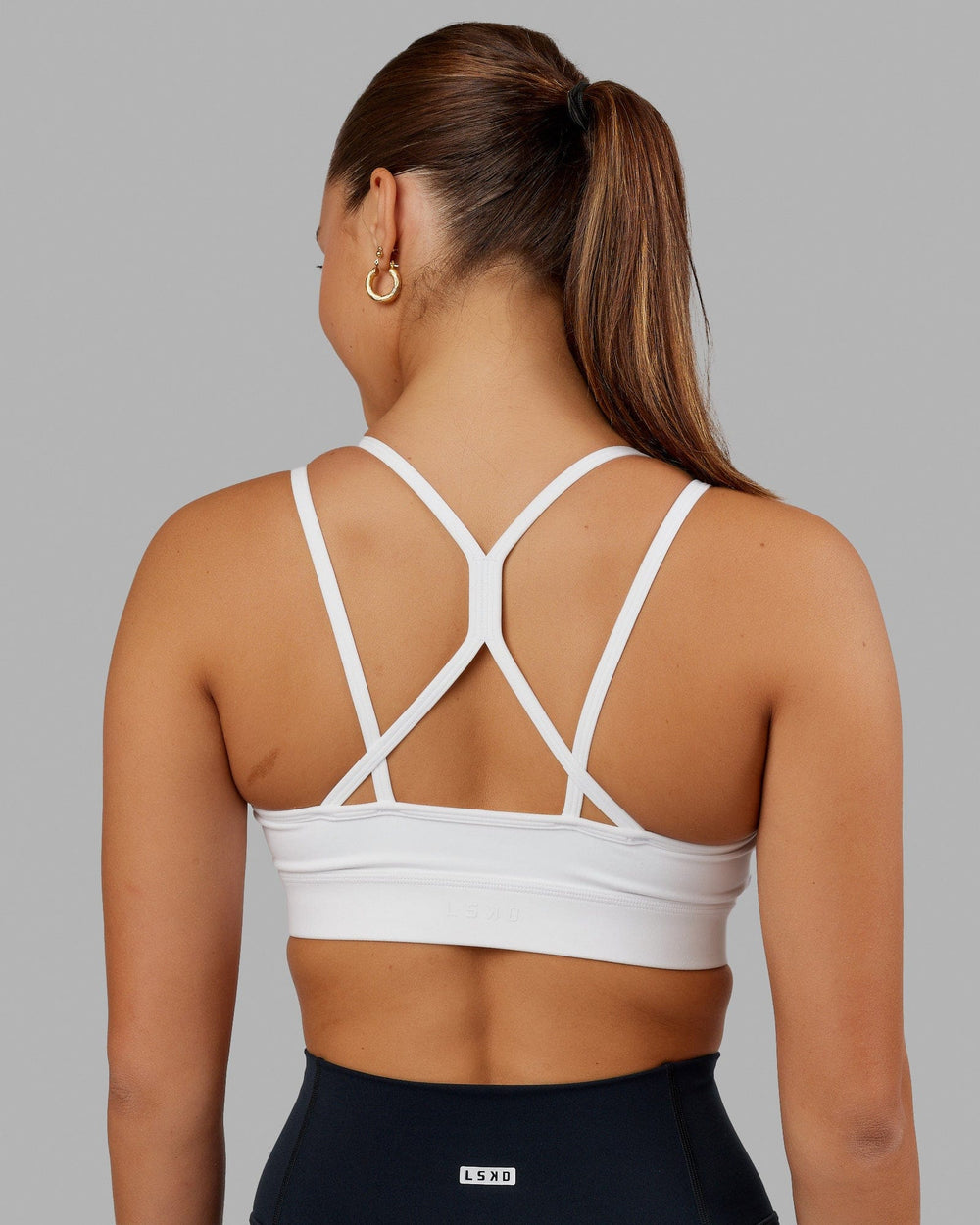 Woman wearing Bridge Sports Bra - White