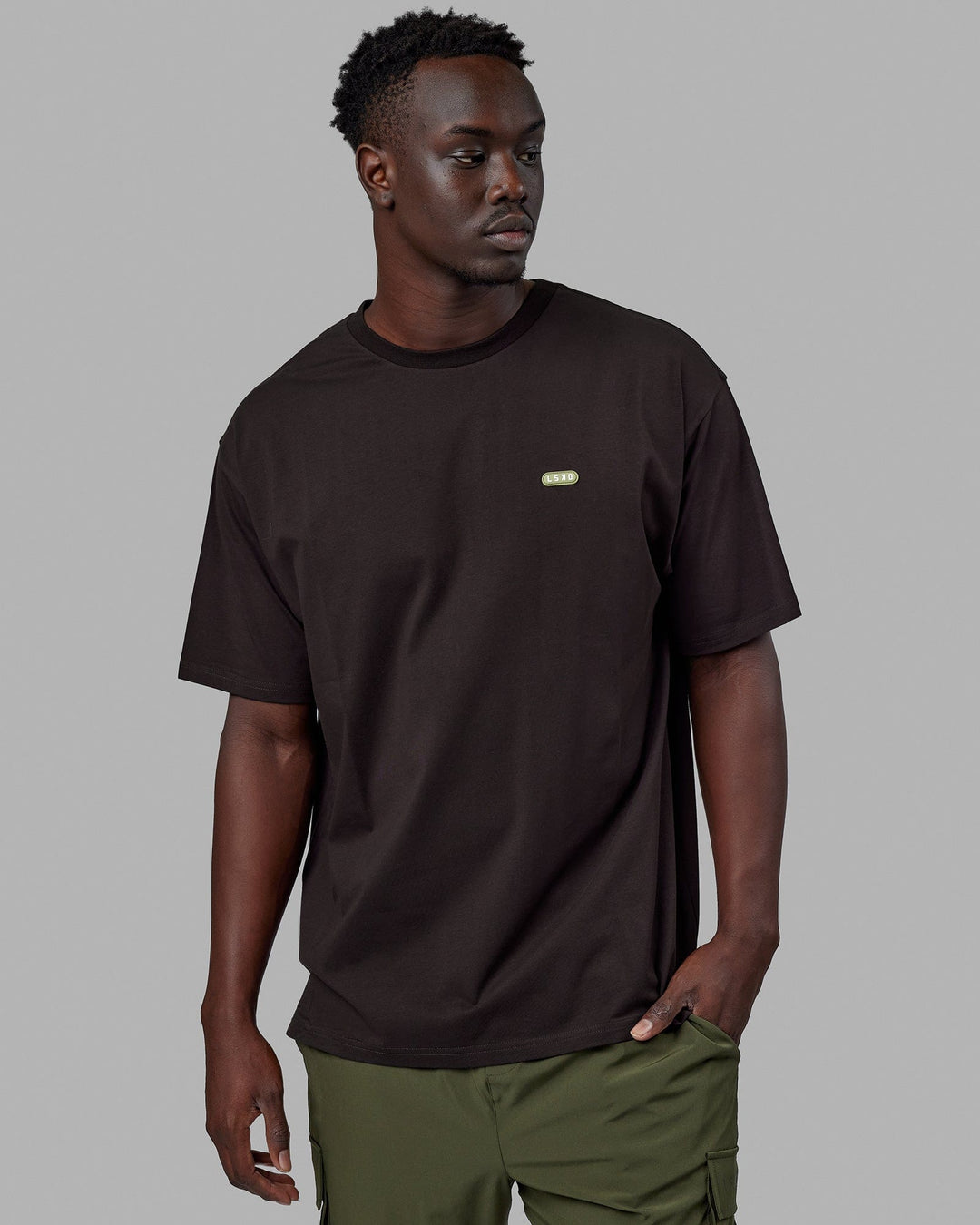 Man wearing Unisex Capsule FLXCotton Tee Oversize - Dark Walnut