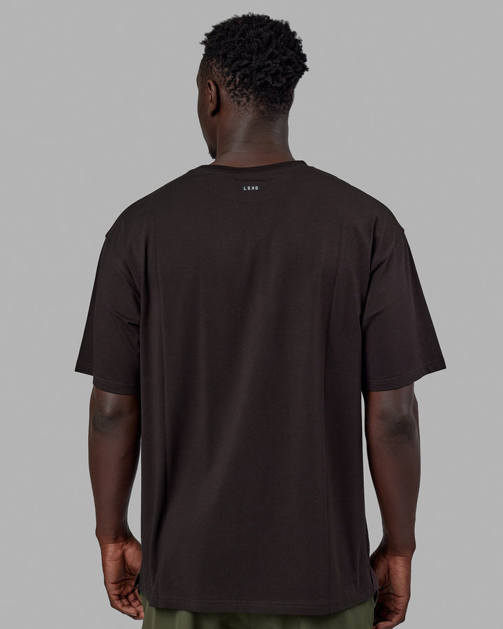 Man wearing Unisex Capsule FLXCotton Tee Oversize - Dark Walnut