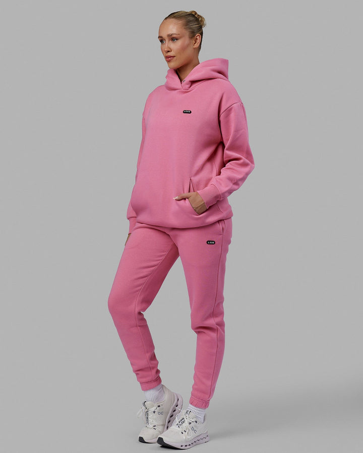 Woman wearing Unisex Capsule Hoodie Oversize - Pink Rose