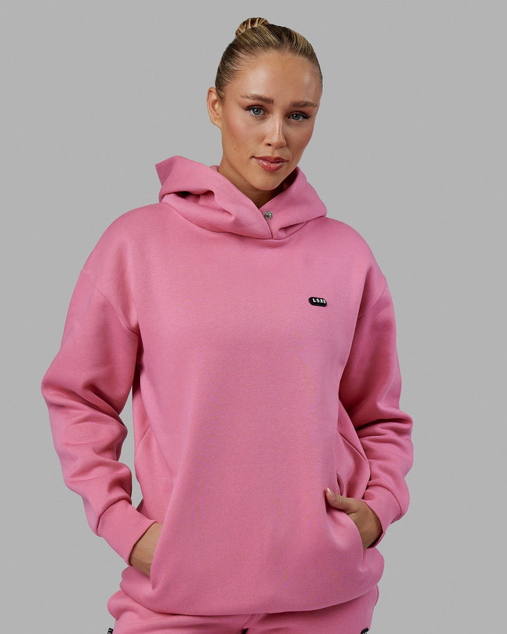 Woman wearing Unisex Capsule Hoodie Oversize - Pink Rose