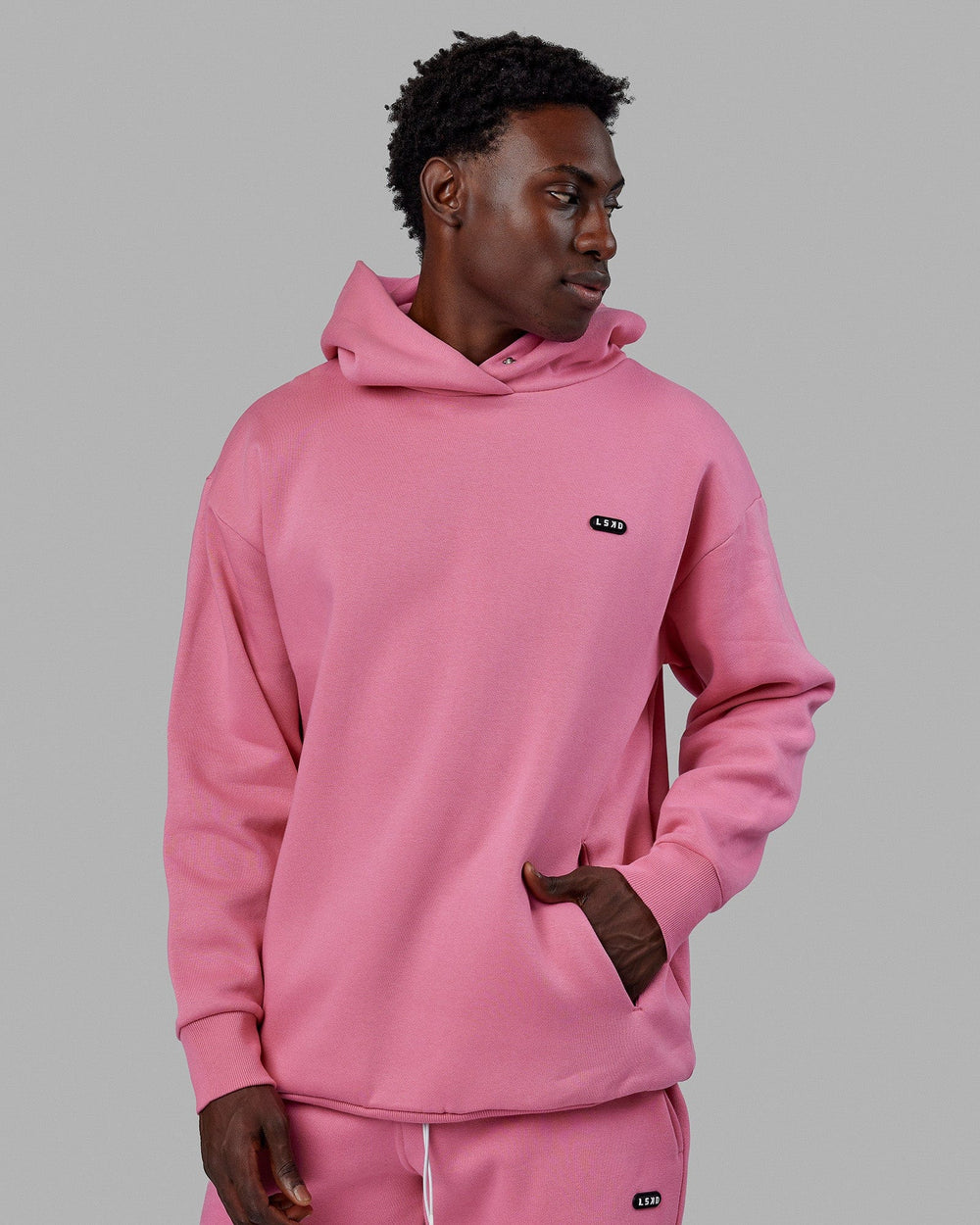 Man wearing Unisex Capsule Hoodie Oversize - Pink Rose
