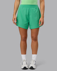 Woman wearing Challenger 5" Lined Performance Shorts - Mystic Green