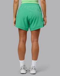 Woman wearing Challenger 5" Lined Performance Shorts - Mystic Green