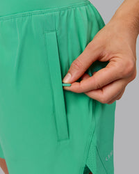Woman wearing Challenger 5" Lined Performance Shorts - Mystic Green