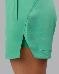 Woman wearing Challenger 5" Lined Performance Shorts - Mystic Green