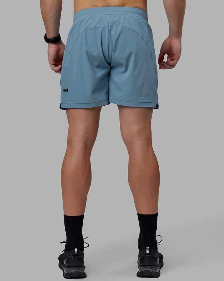 Man wearing Challenger 6" Lined Performance Shorts - Elemental Blue