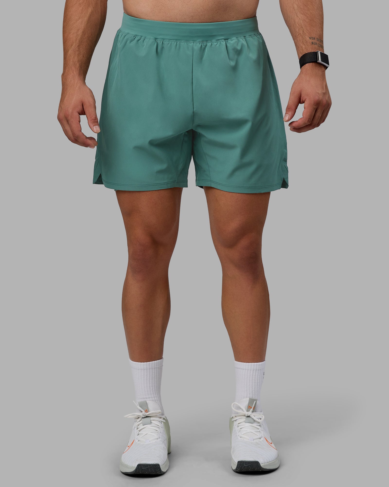 Man wearing Challenger 6" Lined Performance Shorts - Sagebrush