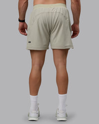 Man wearing Challenger 6" Lined Performance Shorts - Sustained Grey