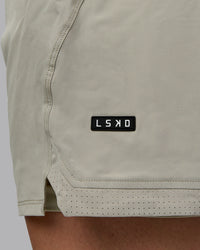Man wearing Challenger 6" Lined Performance Shorts - Sustained Grey