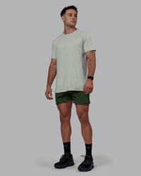 Man wearing Challenger 6" Performance Shorts - Cilantro