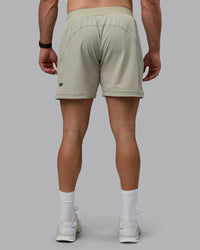 Man wearing Challenger 6" Performance Shorts - Sustained Grey