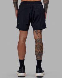 Man wearing Challenger 6" Lined Performance Short - Black