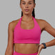 Woman wearing Challenger Sports Bra - Ultra Pink